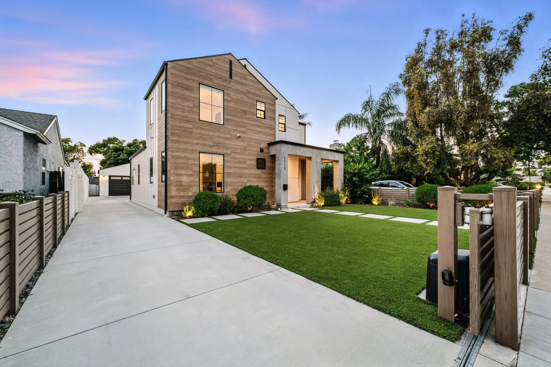 Modern home with horizontal wood fence in front yard