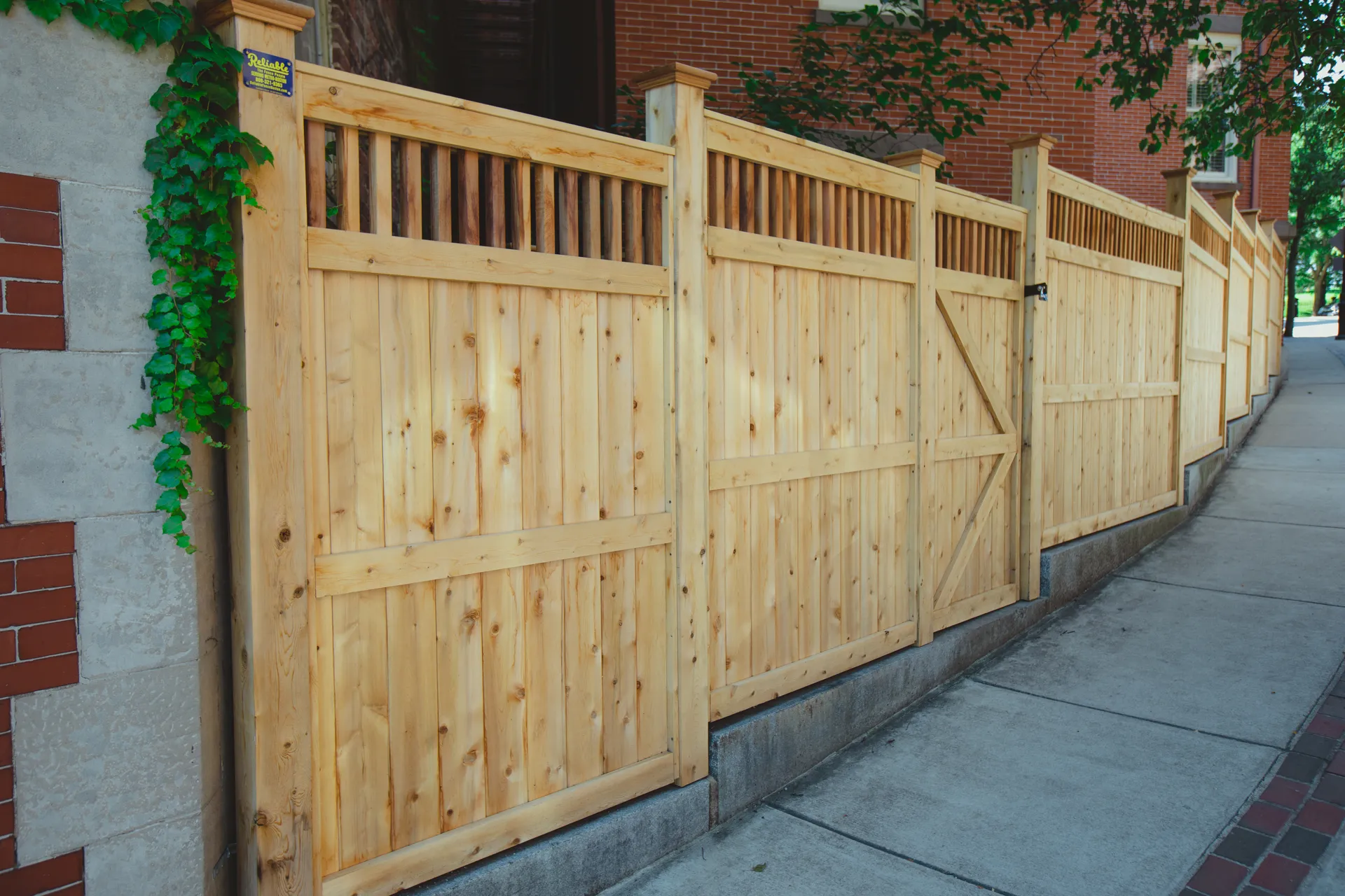 Natural cedar privacy fence with lattice top and gate